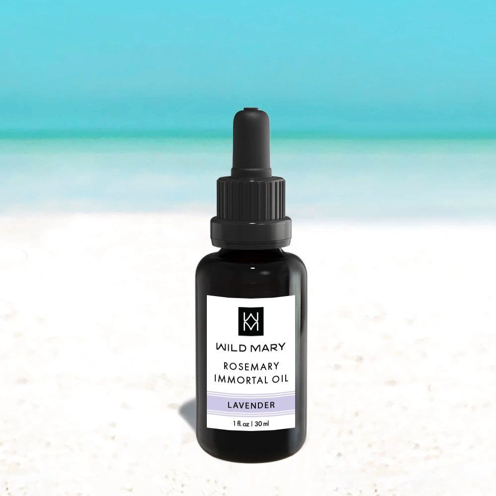 Bottle of Wild Mary Rosemary Lavender Immortal Oil on a light background