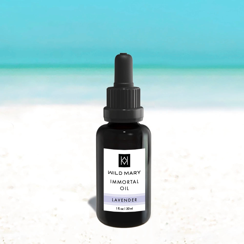 Bottle of Wild Mary Rosemary Lavender Immortal Oil on a light background