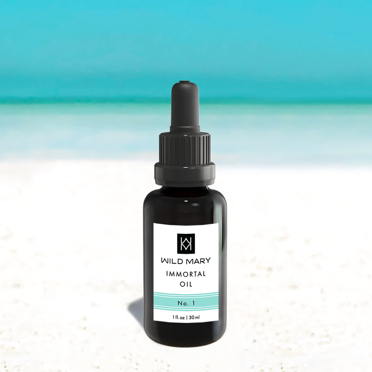 Wild Mary Immortal Oil No. 1 Rosemary Restorative Face Oil in a black glass dropper bottle on Holbox Island beach