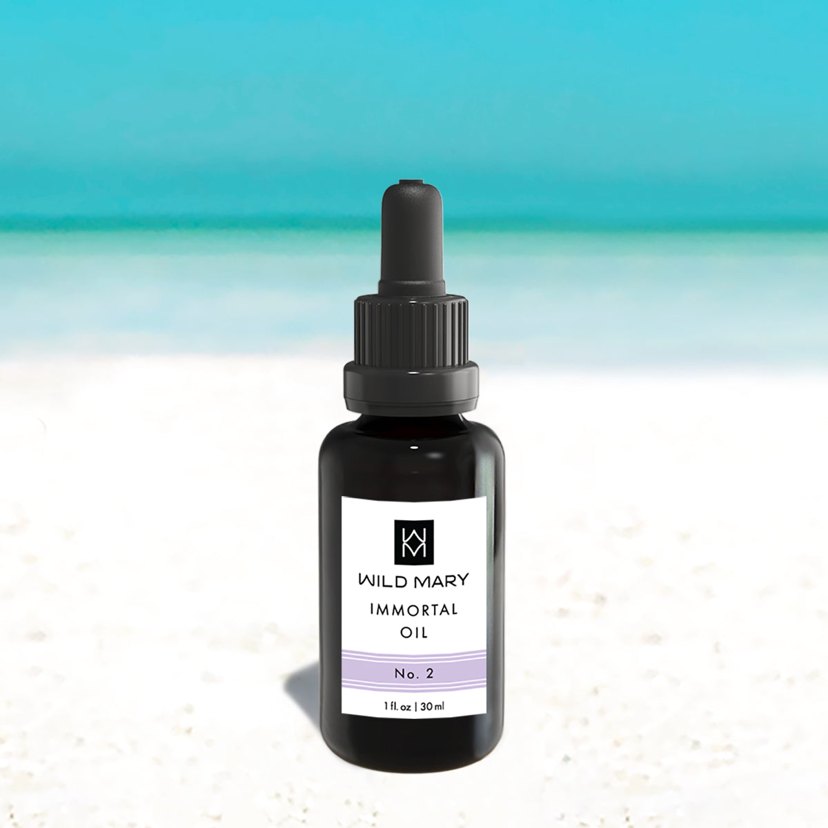 Wild Mary Immortal Oil No. 2 Lavender Restorative Face Oil in a black glass dropper bottle on Holbox Island beach
