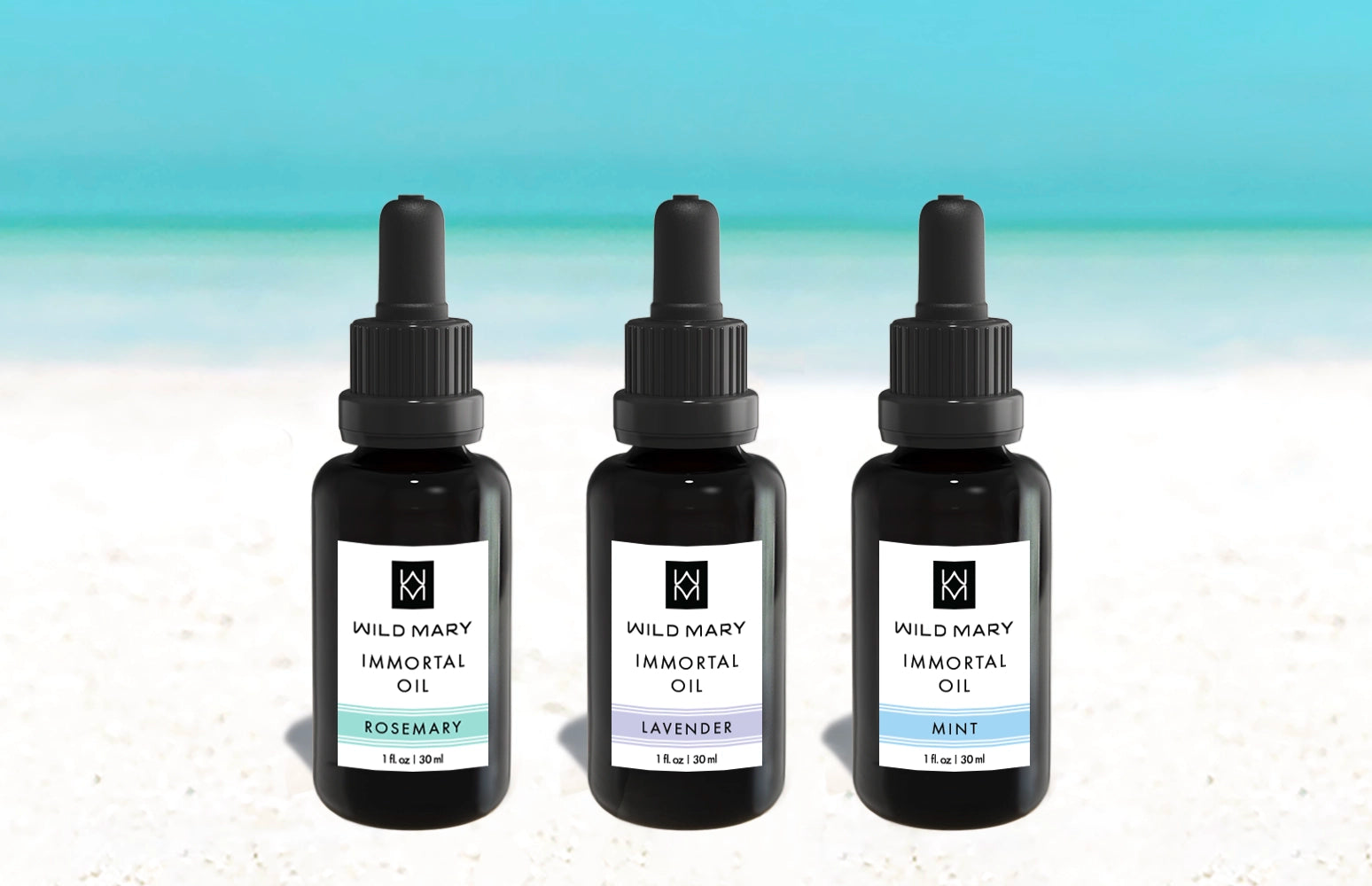 Wild Mary Immortal Oil Trio — three face oil bottles in Rosemary, Lavender, and Mint on a beach background with white sand and light blue sky.
