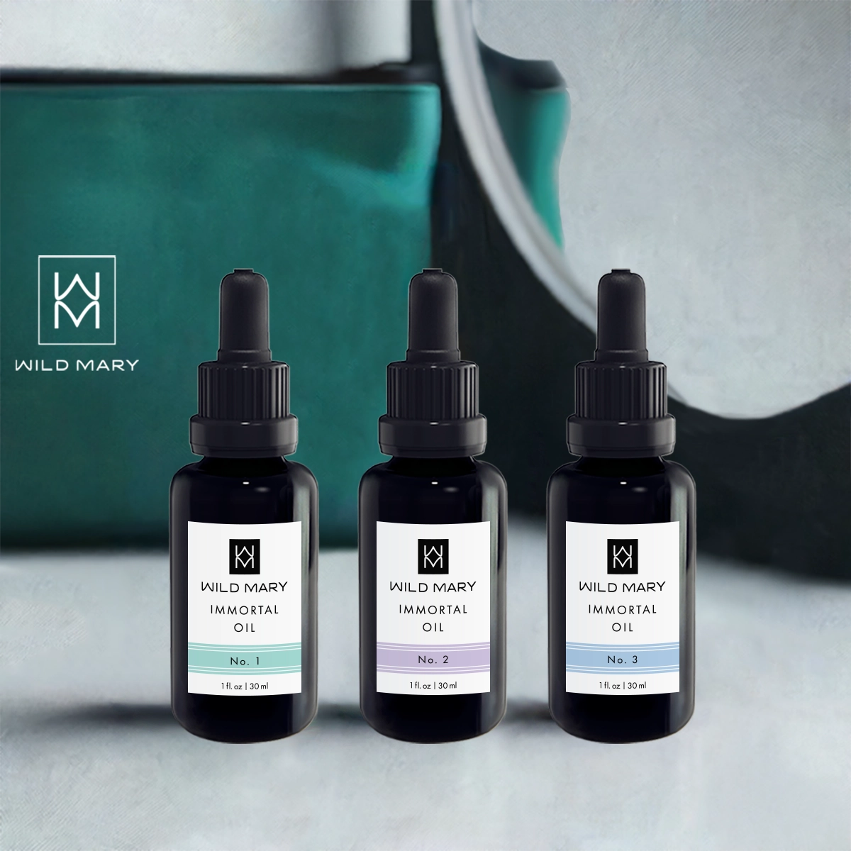 Wild Mary Immortal Oil Trio featuring No. 1 Rosemary, No. 2 Lavender, and No. 3 Rosemary Mint Restorative Face Oils on a vanity.