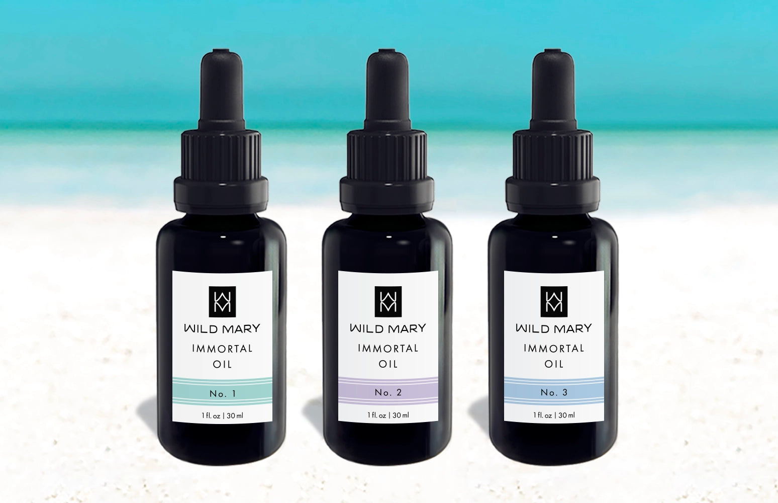 Wild Mary Immortal Oil Trio featuring No. 1 Rosemary, No. 2 Lavender, and No. 3 Rosemary Mint Restorative Face Oils on Holbox Island beach