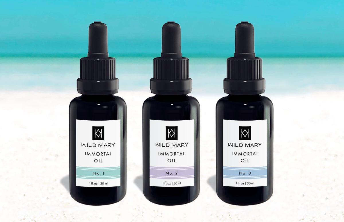 Wild Mary Immortal Oil Trio featuring No. 1 Rosemary, No. 2 Lavender, and No. 3 Rosemary Mint Restorative Face Oils on Holbox Island beach