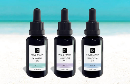 Wild Mary Immortal Oil Trio featuring No. 1 Rosemary, No. 2 Lavender, and No. 3 Rosemary Mint Restorative Face Oils on Holbox Island beach