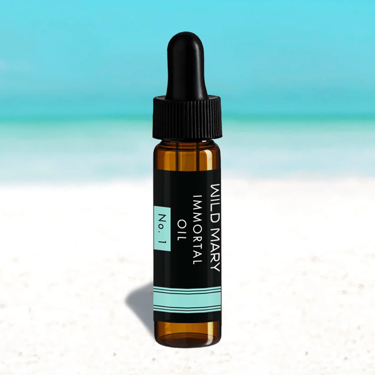 Wild Mary Mini Immortal Oil No. 1 Rosemary Restorative Face Oil in a black glass dropper bottle on Holbox Island beach