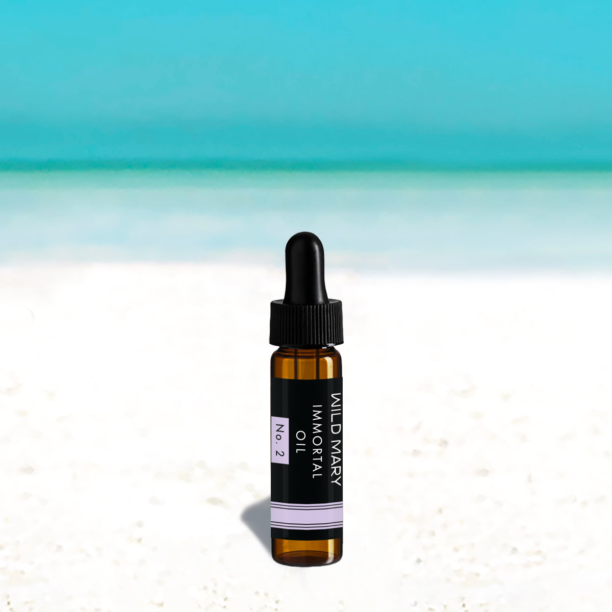 Wild Mary Mini Immortal Oil No. 2 Lavender Restorative Face Oil in a black glass dropper bottle on Holbox Island beach