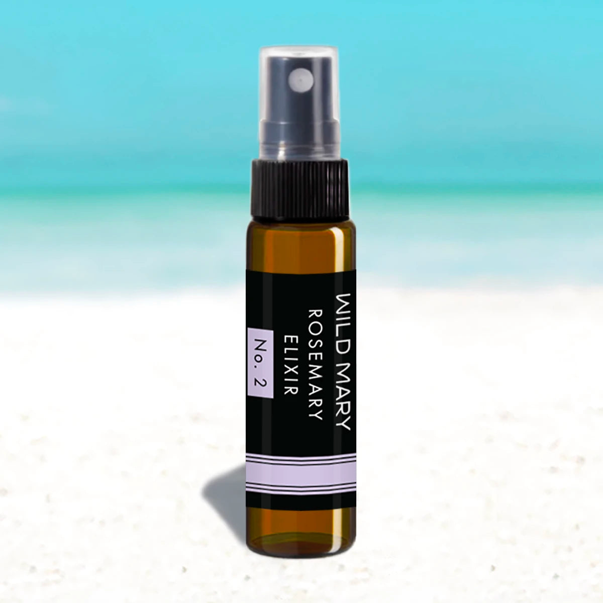 Wild Mary Mini Rosemary Elixir No. 2 Lavender Milky Essence Toner in an amber glass spray bottle on Holbox Island beach