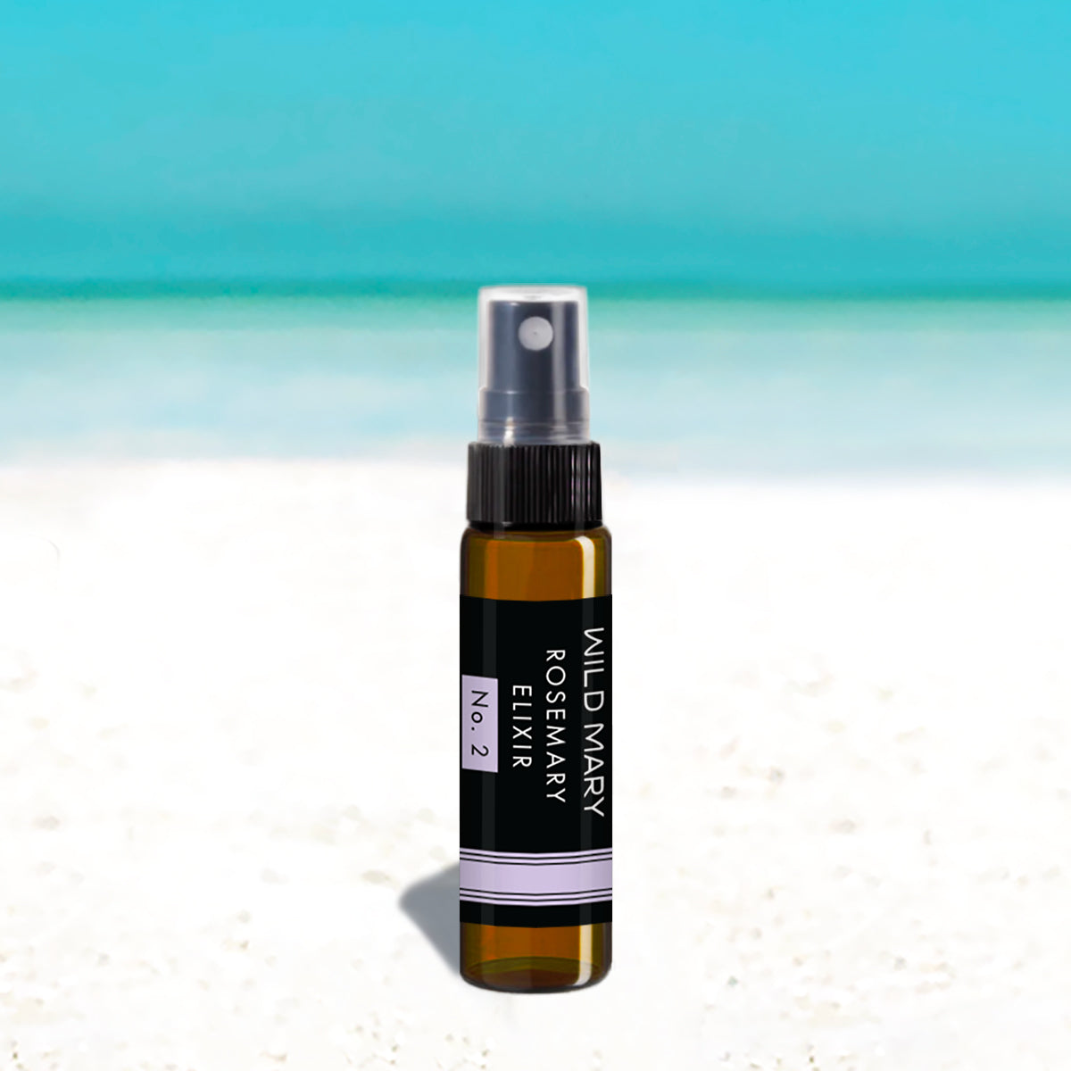 Wild Mary Mini Rosemary Elixir No. 2 Lavender Milky Essence Toner in a black glass spray bottle on Holbox Island beach