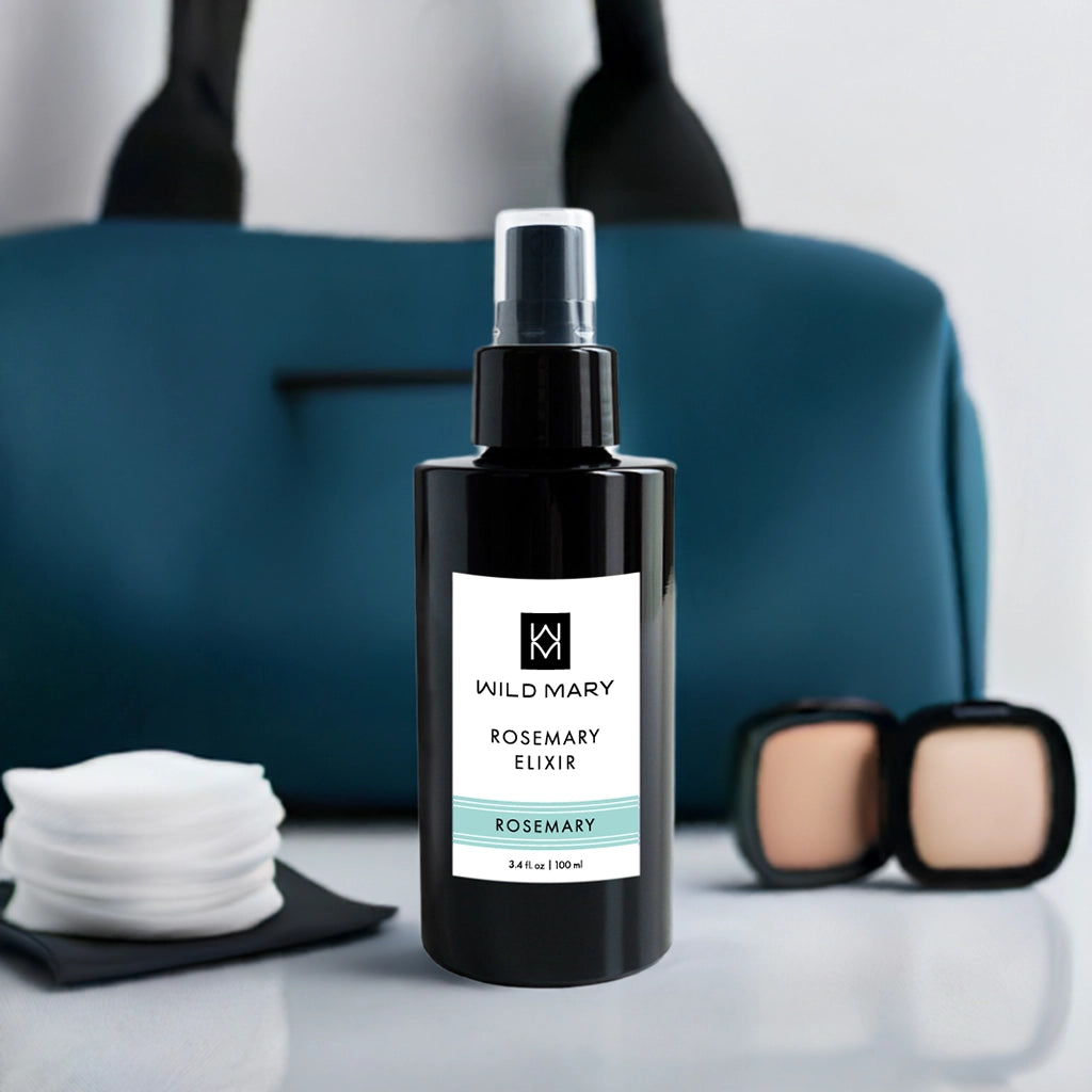 Wild Mary Rosemary Elixir 100 ml bottle with cotton pads and makeup accessories, styled product photo.